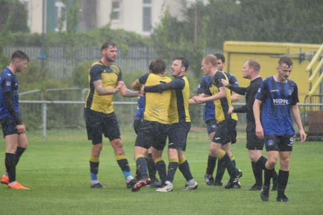 Moneyfields' Jake Knight (back to camera) has to be restrained from confronting Clanfield's Mike McCormack following the foul which brought a red card. Picture: Dan (JMA Media).