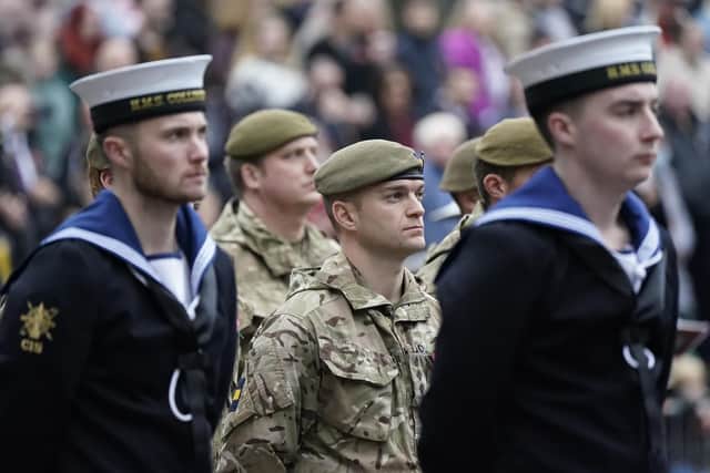 Military personnel parade in the Guildhall Square, in Portsmouth, during a Remembrance Service. Picture date: Sunday November 14, 2021.