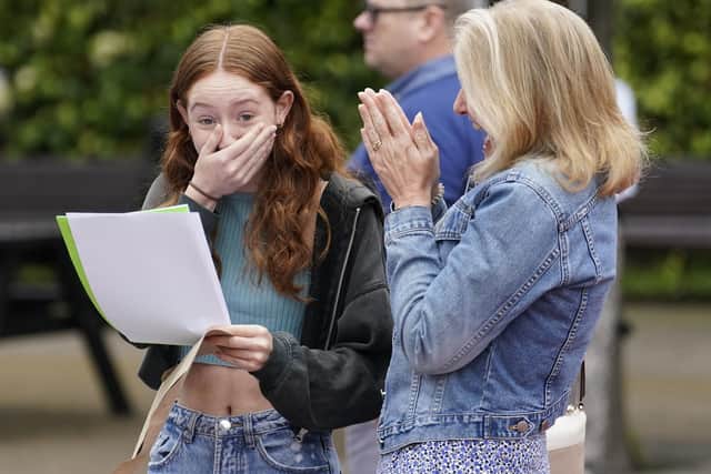 Annabel Bolton (left) receiving her GCSE results with her mother Helen at Portsmouth Grammar School, in Hampshire. Pic: Andrew Matthews/PA Wire