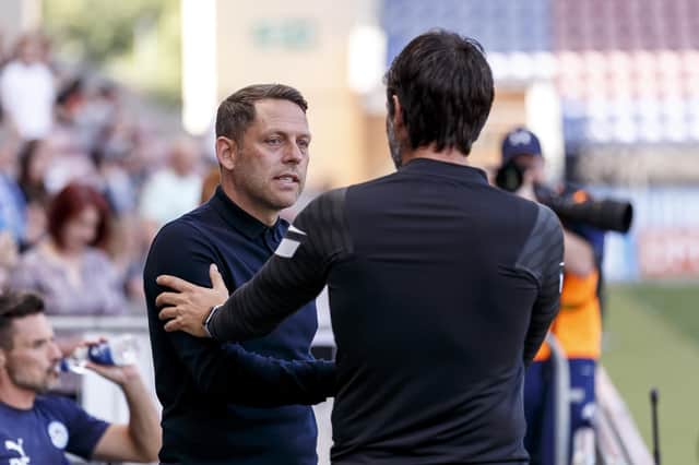 Danny Cowley greets Wigan boss Leam Richardson before Pompey's 1-0 defeat last weekend. They are among seven former Premier League clubs in a tough League One this season. Picture: Daniel Chesterton/phcimages.com