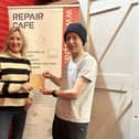 Gosport MP Caroline Dinenage gives a donation to Keith Brady, chair of Repair Cafe Gosport.
