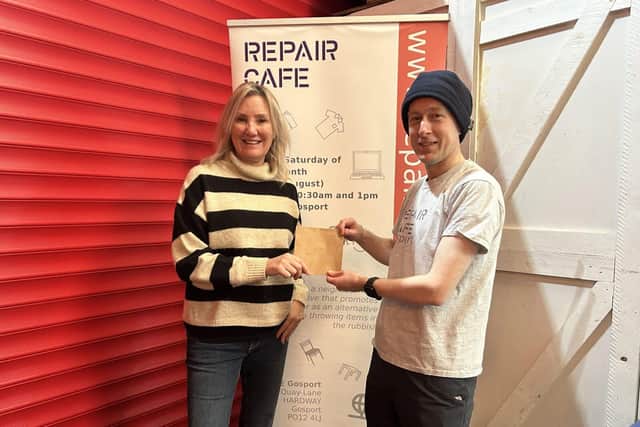Gosport MP Caroline Dinenage gives a donation to Keith Brady, chair of Repair Cafe Gosport.