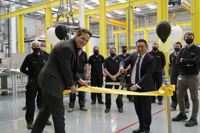 Left, Matt Bylett, head of operations at Sartorius Stedim Chromatography, with MP Alan Mak as he cuts the ribbon at the site.