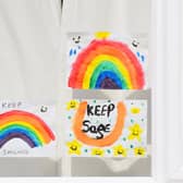 Drawings by children in the windows of houses as kids are encouraged to put pictures of rainbows with positive messages in their windows during the coronavirus covid-19 lockdown in April 2020.