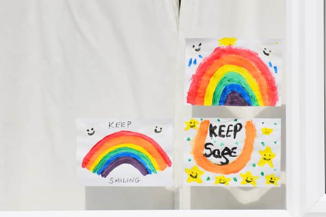 Drawings by children in the windows of houses as kids are encouraged to put pictures of rainbows with positive messages in their windows during the coronavirus covid-19 lockdown in April 2020.