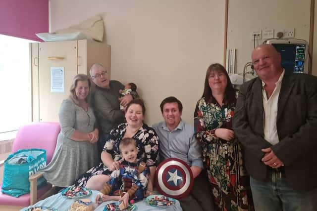 Aiden Lewis (middle) with his family 