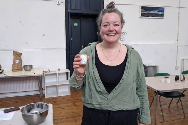 Jemma Corbin holding one of her candles at the workshop. Picture: Emily Turner