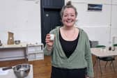 Jemma Corbin holding one of her candles at the workshop. Picture: Emily Turner