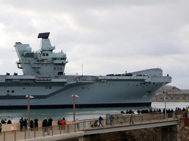 Delighted onlookers watch HMS Queen Elizabeth returning to Portsmouth Naval Base