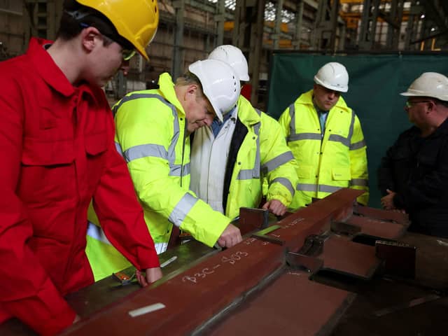 Prime Minister Boris Johnson marks a piece of metal, at the Cammel Laird shipyard in Merseyside. Picture date: Thursday March 10, 2022.  Photo by: Phil Noble/PA Wire