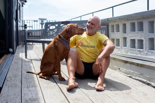 Jason West will be running The Great South Run in bare feetPictured: Jason West with his dog, Horatio at his home in Southsea in September 2023Picture: Habibur Rahman