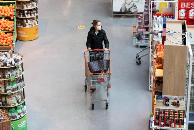 A woman wears a face mask while shopping in a supermarket. Picture: ALEX HALADA/AFP via Getty Images