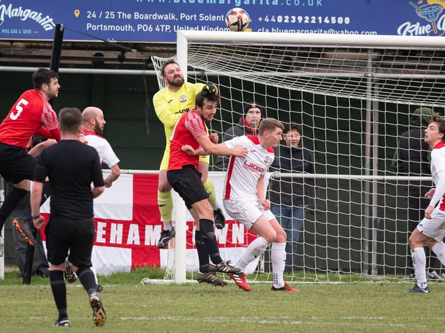 Horndean goalkeeper Cameron Scott punches clear. Picture: Keith Woodland