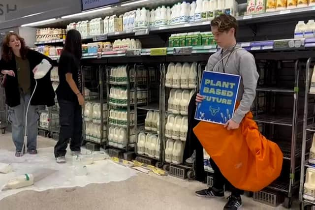 Handout photo issued by Animal Rebellion of supporters of Animal Rebellion pouring out milk in a Waitrose in Edinburgh. Issue date: Saturday October 15, 2022.