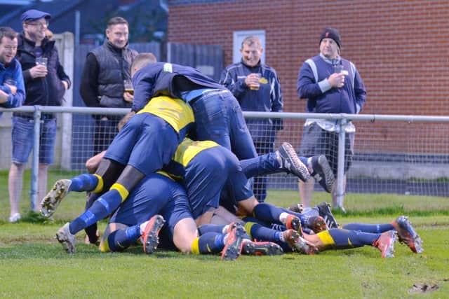 Bundle! Moneyfields players celebrate Steve Hutchings' injury-time winner in the FA Trophy tie against Kidlington. Picture: Martyn White.