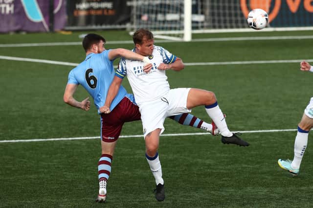 Makeshift striker Jamie Collins battles with Weymouth's Nathan Carlyle. Picture by Dave Haines
