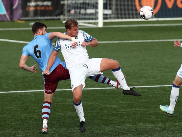 Makeshift striker Jamie Collins battles with Weymouth's  Nathan Carlyle. Picture by Dave Haines