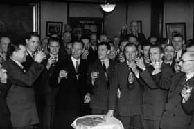 Pompey players and backroom staff celebrate the club's championship win at the end of the 1948-49 season with Tom Holland (with the moustache) in the centre at the back.