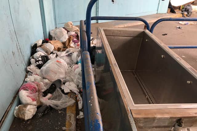 Bin bags, broken freezer units, and old sofas are among the rubbish left strewn across the site.