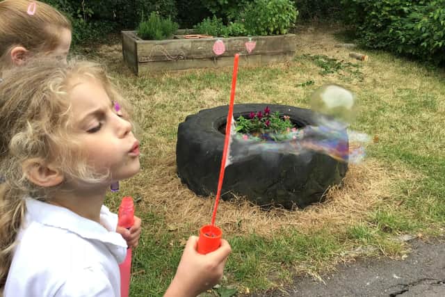 Damson Lamb, 7, blows her troubles away with bubbles.