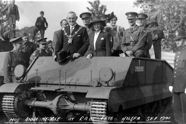 The young lady surrounded by officers and the mayor is actress Anna Neagle. She  was attending a fete at the R.A.O.C. Barracks at Hilsea in September 1941.
Miss Neagle was the star of many films  more well known  as Queen Victoria in Victoria the Great 1937 and Sixty Glorious Years 1938. She also appeared as Nurse Edith Cavel, 1939.
Dame Anna Neagle at the R.A.O.C. Barracks in September 1941.