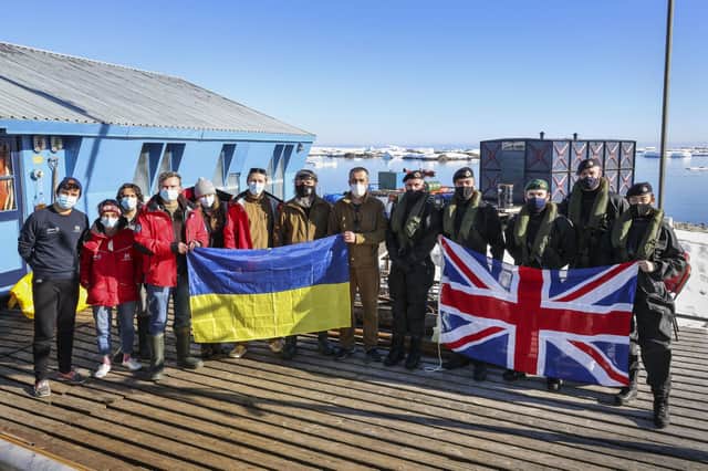 The visit team from HMS Protector, led by Captain Michael Wood, alongside Base Commander Bogdan Gavrylyuk and some of the Vernadsky base staff Picture: LPhot Belinda Alker