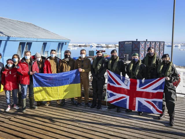 The visit team from HMS Protector, led by Captain Michael Wood, alongside Base Commander Bogdan Gavrylyuk and some of the Vernadsky base staff Picture: LPhot Belinda Alker