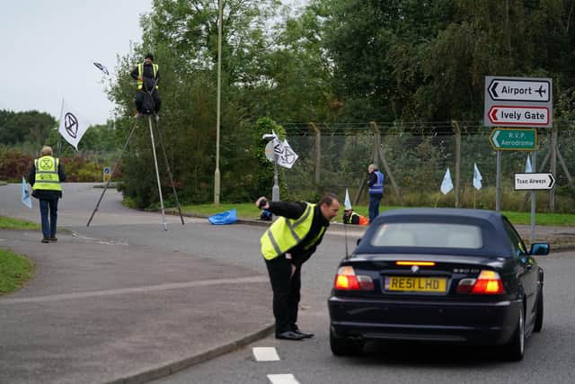 Extinction Rebellion activists protest outside Farnborough Airport in Hampshire in protest against emissions from private jets. Picture date: Saturday October 2, 2021. PA Photo. See PA story ENVIRONMENT Airport. Photo credit should read: Andrew Matthews/PA Wire