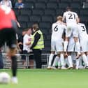 MK Dons players celebrate following Ethan Robson's decisive goal in the 71st minute against Pompey. Picture: Jason Brown