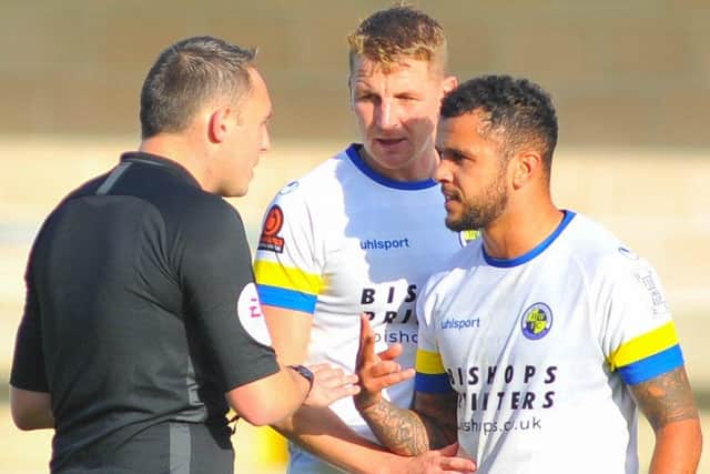 Joe Oastler and Billy Clifford have words with referee Dale Wootton at Plainmoor. Picture: Martyn White.