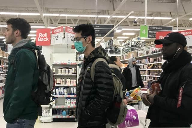A man wearing a face mask in the Clapham Junction branch of ASDA, London, as Shadow Health Secretary Jonathon Ashworth says he would support shutting down cities to control the spread of coronavirus. Pic: Kirsty O'Connor/PA Wire