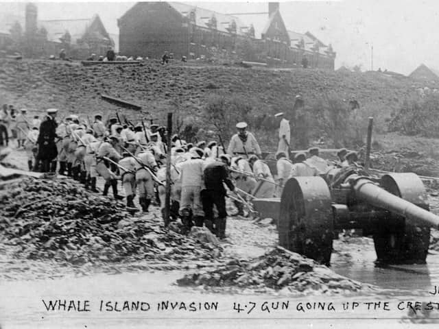 The White Force hauls a gun out of the mud and on to Whale Island during the Great War in 1904.