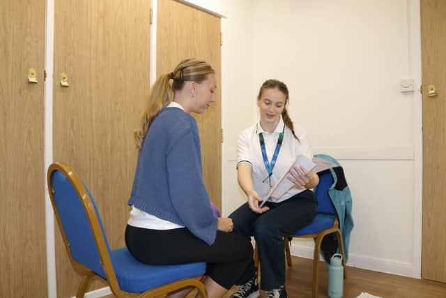 Staff members demonstrating a station.