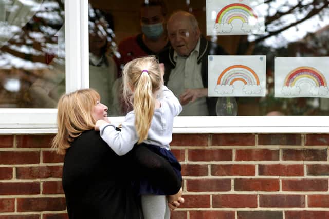 Wendy Fenn, a staff member at Growing Places, holds Hope Goodson at one of the intergenerational visits at Woodlands Care Home, Waterlooville.