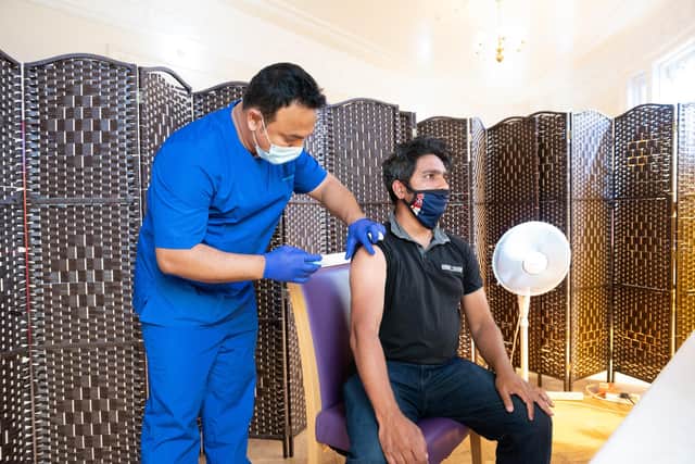 Locals being vaccinated at the Jami Mosque on the 15th of June 2021. Habibur Rahman being given his second vaccine by Doctor Ebadur Chowdhury.