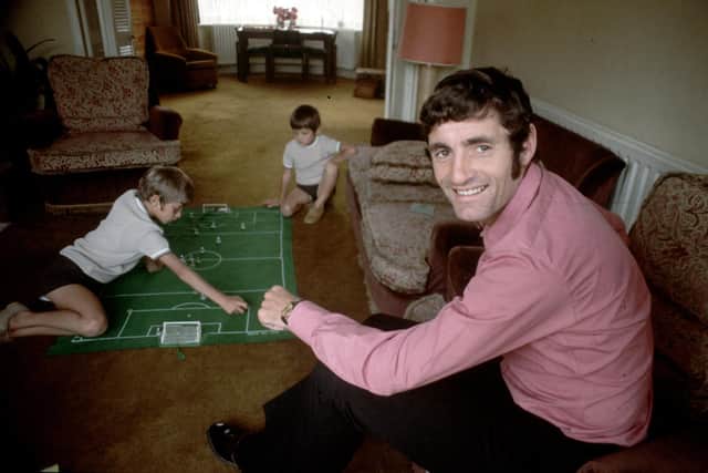 Arsenal's Frank McLintock at home watching his children playing Subbuteo in the early 1970s. Hopefully a similar scene will be had in the homes of Liverpool and Manchester City players this Christmas. Photo by Express/Express/Getty Images.