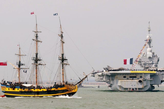 Tall ship The Grand Turk (foreground) passes by French aircraft carrier FS Charles de Gaulle during the International Fleet Review at Spithead, off Portsmouth, Tuesday June 28, 2005.  A total of 167 ships from the Royal Navy and 35 nations are taking part in the International Fleet Review at Spithead, off Portsmouth, as part of the Trafalgar 200 celebrations this week. See PA Story SEA Trafalgar. PRESS ASSOCIATION Photo. Photo credit should read: Gareth Fuller/PA