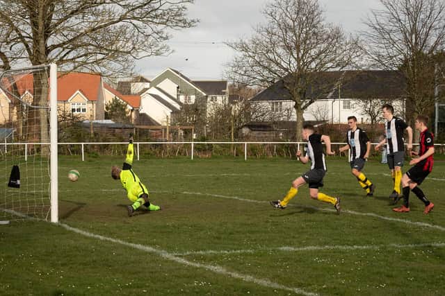 Jack Bishop fires home the rebound for Hayling's third goal after Ben Schneider had saved Josh Elmes' penalty. Picture: Keith Woodland.