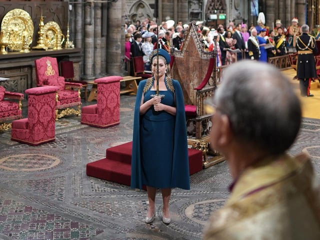Penny Mordaunt holds the Swords of State at the coronation ceremony of King Charles III and Queen Camilla in Westminster Abbey, London.