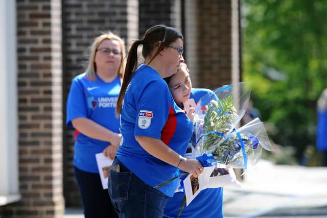 Heartbroken Sarah Merrix hugs her daughter Ellie-Mai, 10, during the funeral..
Picture: Sarah Standing (270420-1122)