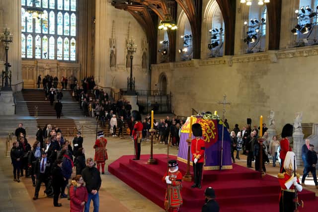 Members of the public view the coffin of Queen Elizabeth II, lying in state on the catafalque in Westminster Hall, at the Palace of Westminster, London. Picture: Carl Court/PA.