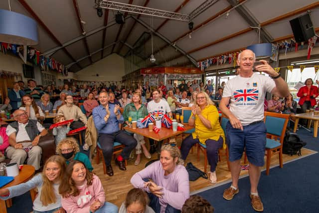 Eilidh McIntyre's father Mike (far right) takes a selfie at Hayling Island Sailing Club this morning. Eilidh's mum, Caroline, is behind in the yellow top. Picture: Habibur Rahman