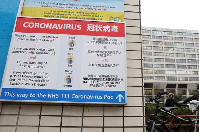 A sign directs patients towards a NHS 111 Coronavirus (COVID-19) Pod. Picture: ISABEL INFANTES/AFP via Getty Images