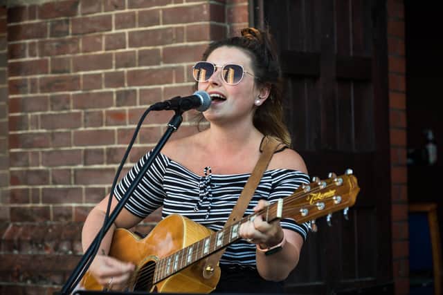 Katie Louise Ball (27) performing at the event. Picture: Mike Cooter (090621)