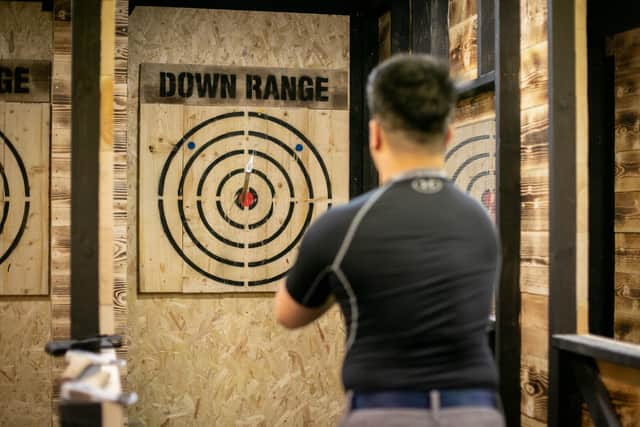 Pictured: Ming Wu having a go at throwing an axe
Picture: Habibur Rahman