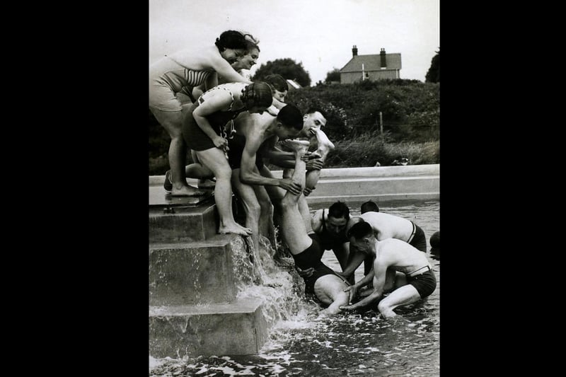 Making Sure Of It, They made sure that this holidaymaker went into the water at the Coronation camp at Hayling Island. His entry into the water was definite if a little undignified, Hayling Island. (Photo by Hulton Archive/Getty Images)