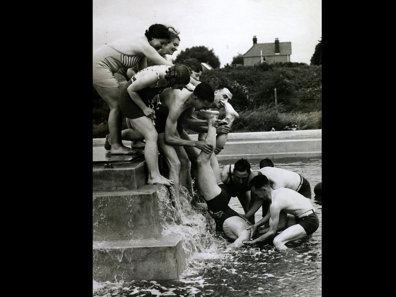 Making Sure Of It, They made sure that this holidaymaker went into the water at the Coronation camp at Hayling Island. His entry into the water was definite if a little undignified, Hayling Island. (Photo by Hulton Archive/Getty Images)