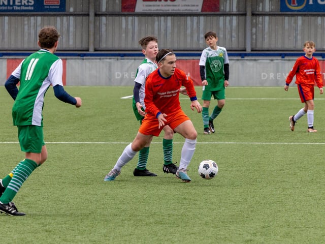 Action from the Under-13 Truman Challenge Cup final between Denmead Youth Lions (orange shirts) and Moneyfields Youth Yellow. Picture: Mike Cooter