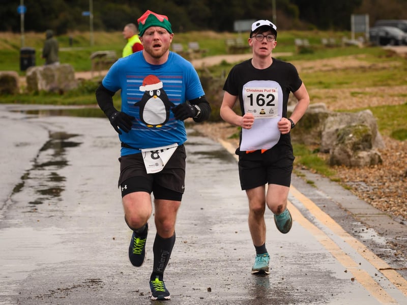 Two runners push to the finish at the Christmas Pud 5K, Stokes Bay, Gosport