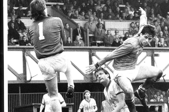 Neil Webb flies through the air but the ball is safely in the arms of Cardiff's keeper Gary Plumley, 1985. The News PP4523